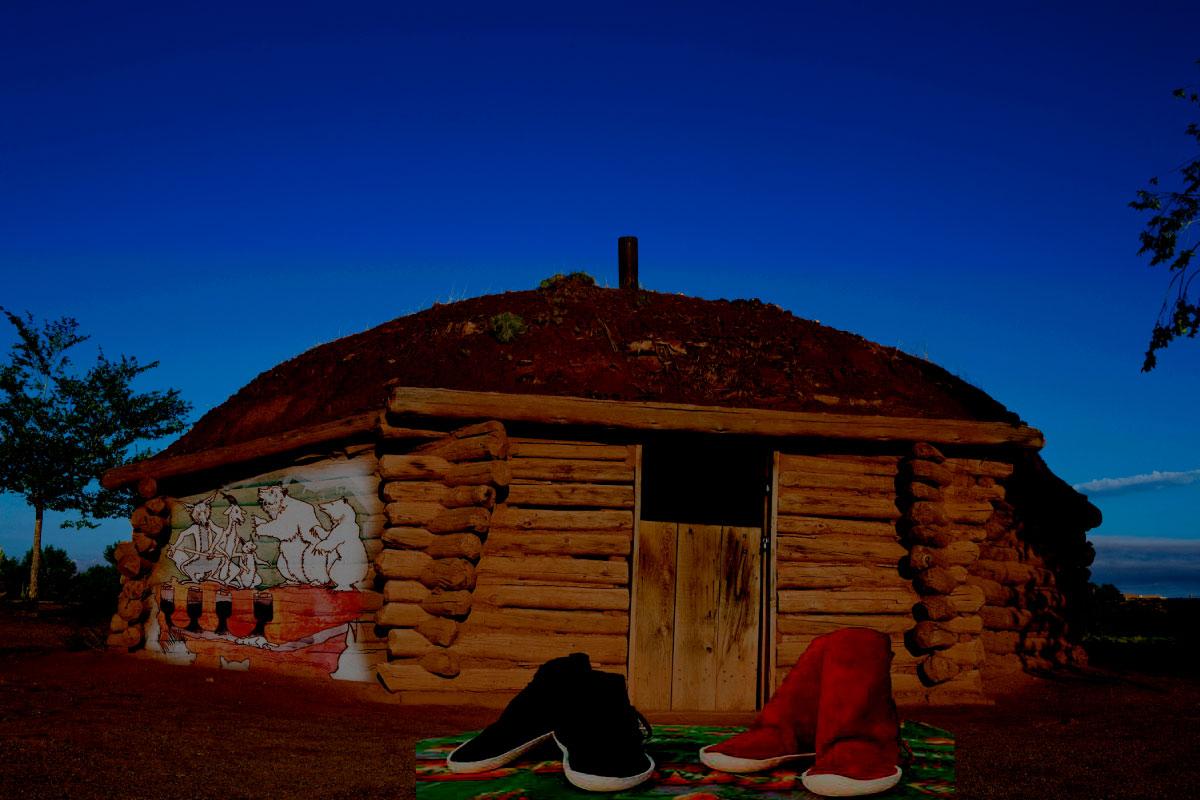 A Navajo traditional home with Navajo moccasins in front